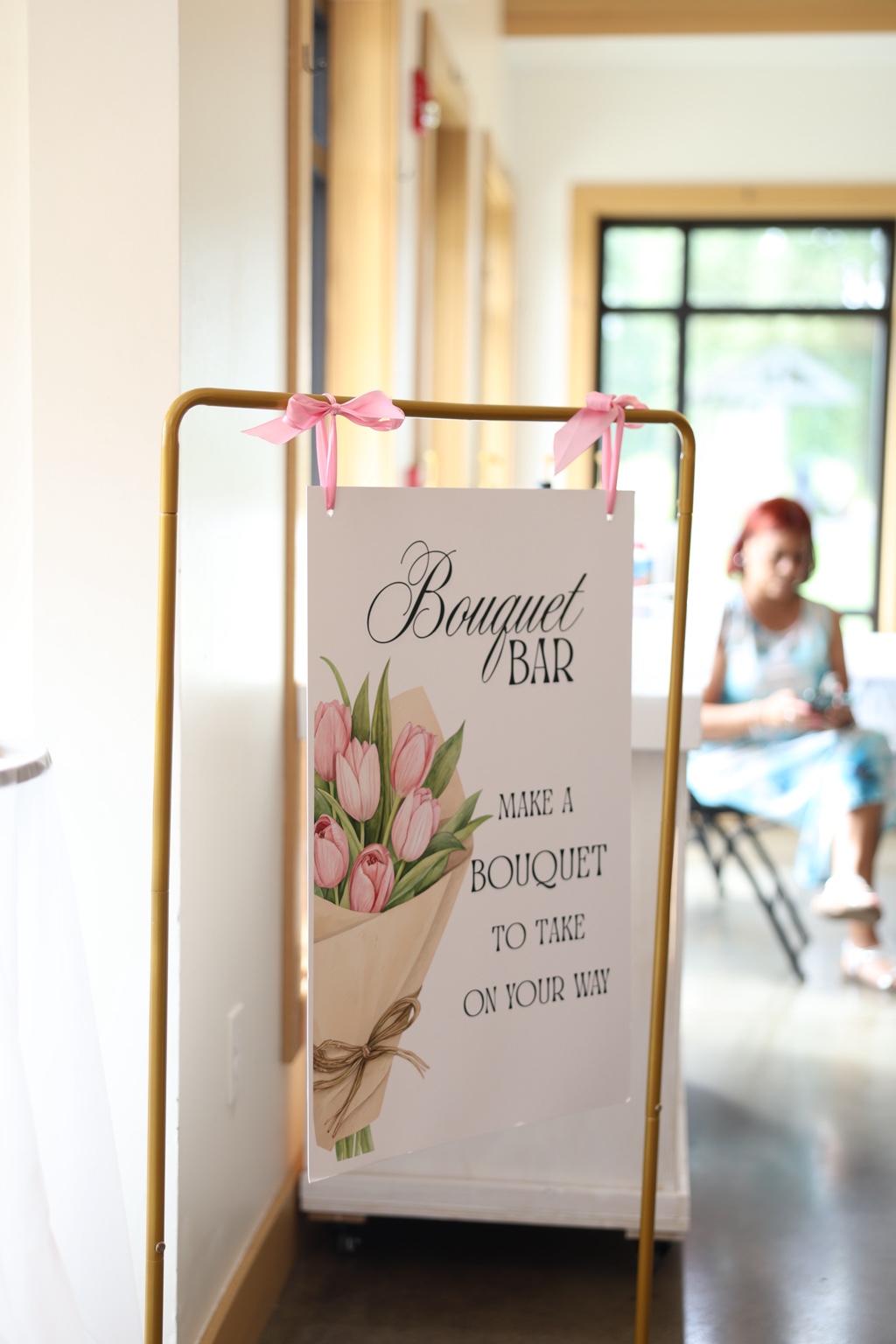 Bouquet bar sign displayed on a gold stand