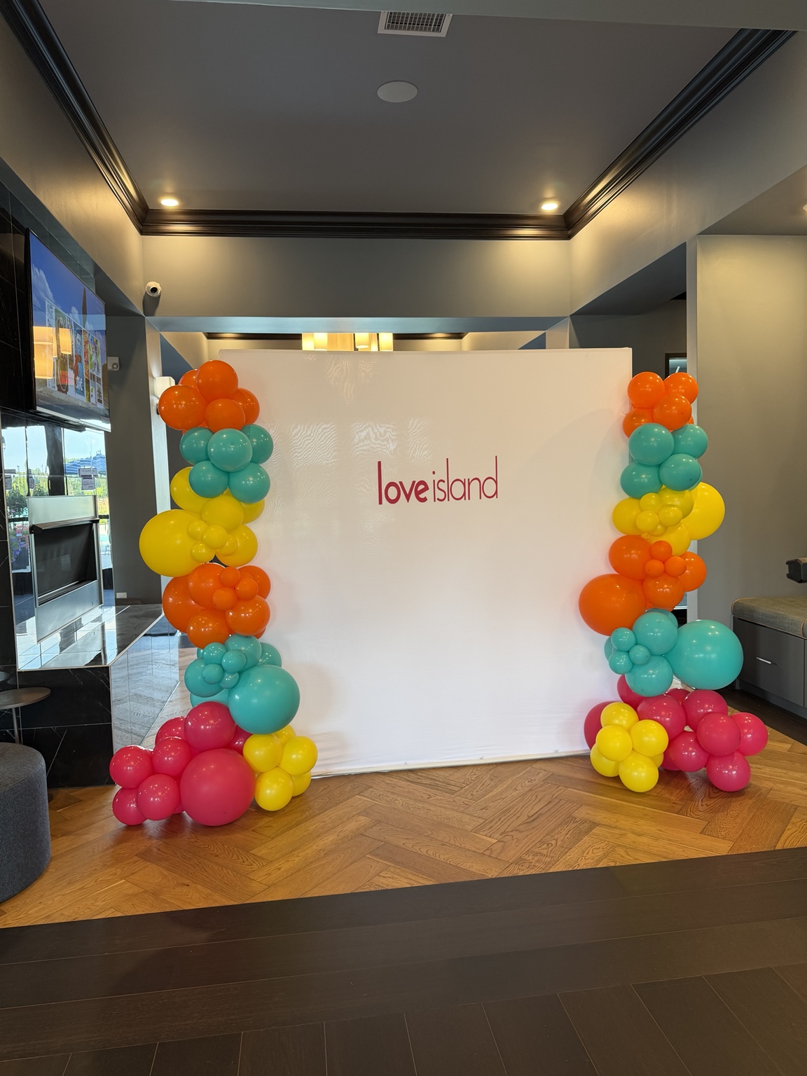Colorful balloon columns around a photo backdrop